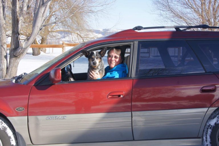 long time client of PNW Insurance Group - Sherrie sitting in Subaru Outback