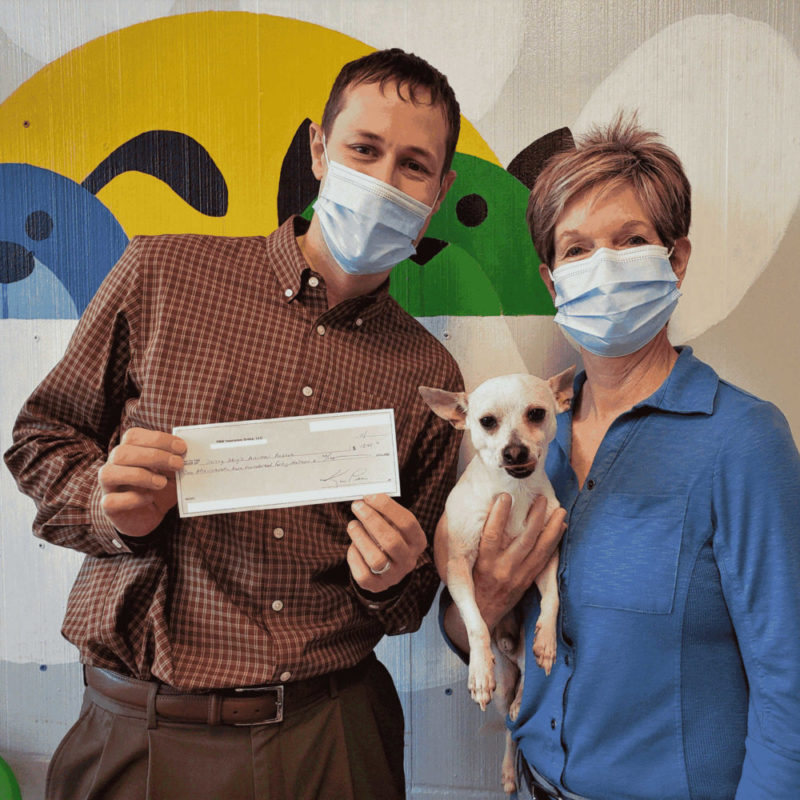 Ryan Stueber and Kim Peters from PNW Insurance Group dropping off donation check to Sunny Skys Animal Rescue